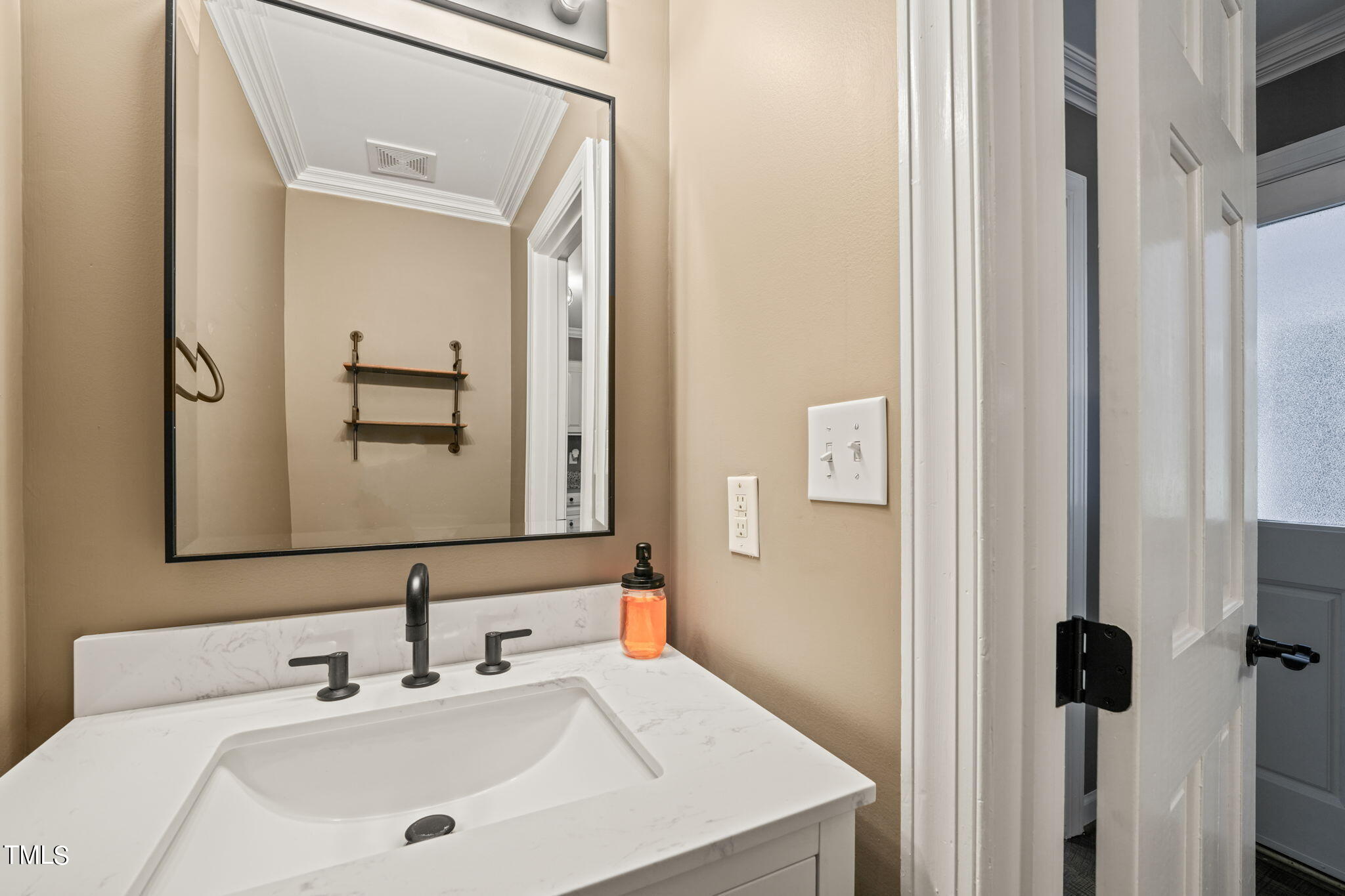 7125 Sandringham Drive Raleigh, NC 27613 - Photo 12 of 26 a bathroom with a sink and a mirror