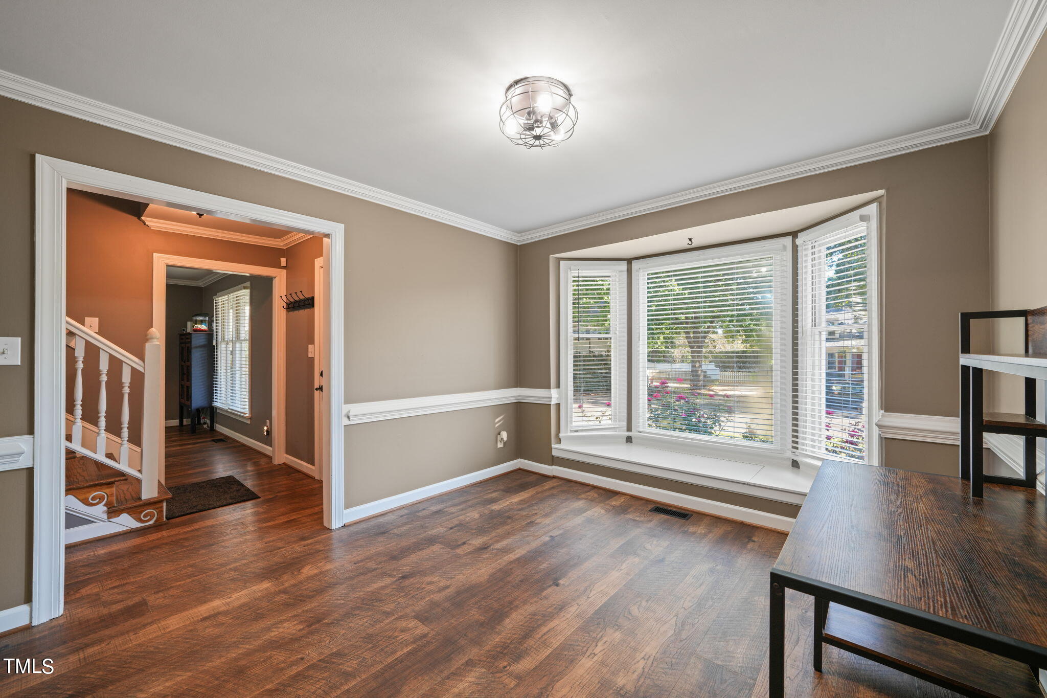 7125 Sandringham Drive Raleigh, NC 27613 - Photo 5 of 26 an empty room with wooden floor and windows