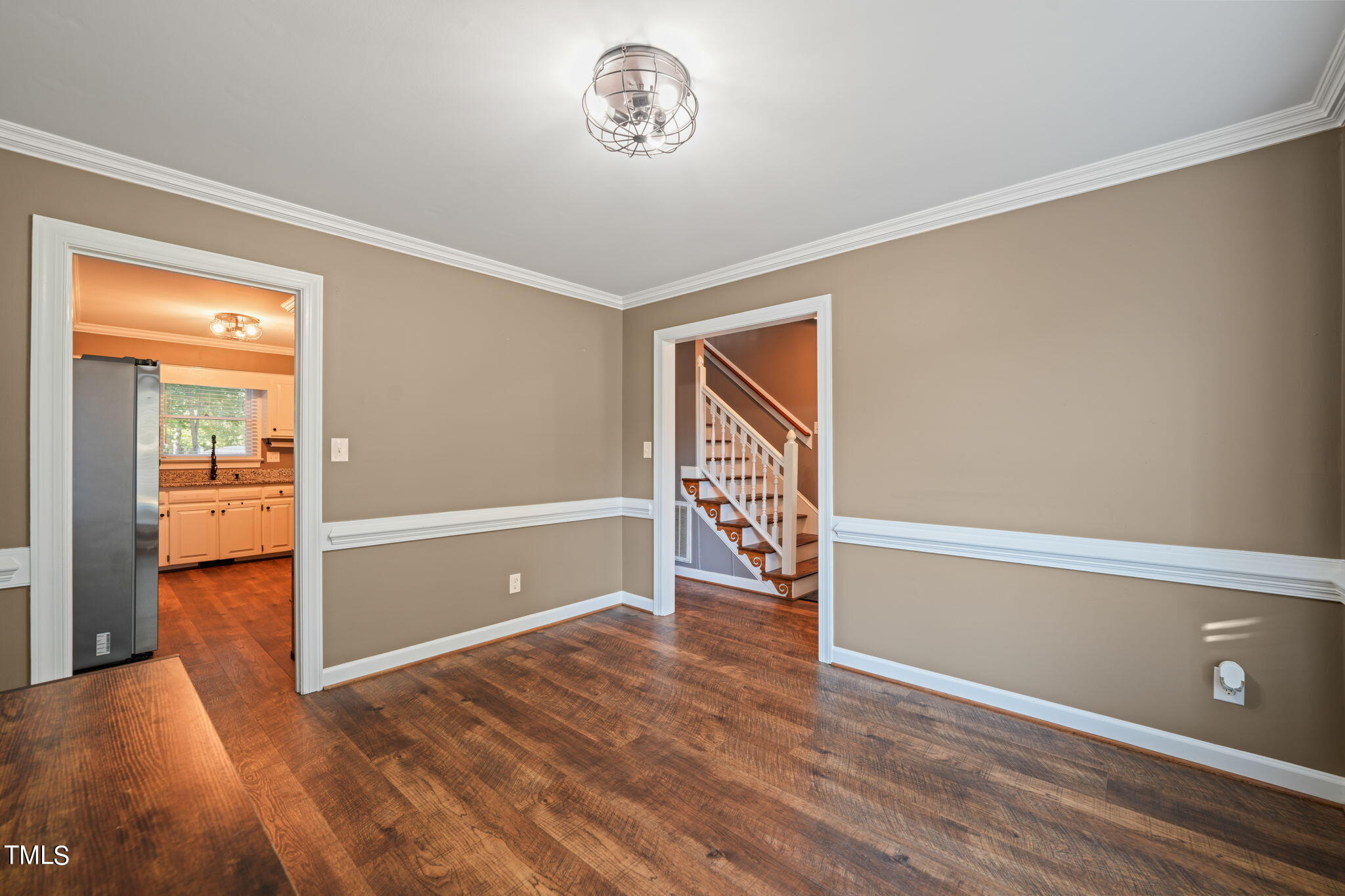 7125 Sandringham Drive Raleigh, NC 27613 - Photo 6 of 26 a view of an empty room with wooden floor
