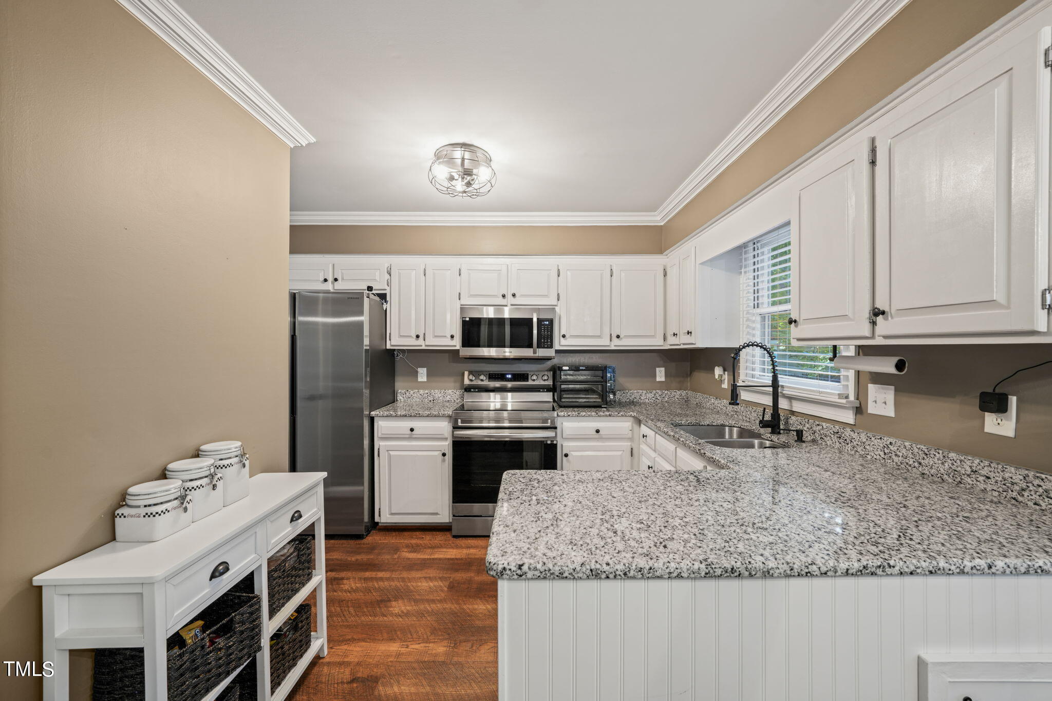 7125 Sandringham Drive Raleigh, NC 27613 - Photo 7 of 26 a kitchen with stainless steel appliances granite countertop a sink stove and refrigerator