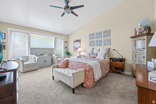 31 Village Square Road Centerville, UT 84014 - Photo 8 of 29 Carpeted room featuring a vaulted ceiling with a ceiling fan, a large window array with blinds, and white trim throughout