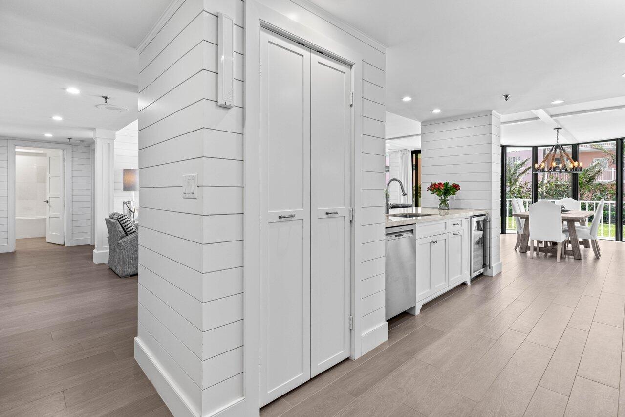 2917 South Ocean Boulevard, Unit 104 Highland Beach, FL 33487 - Photo 13 of 57 a kitchen with stainless steel appliances kitchen island granite countertop a refrigerator and a sink