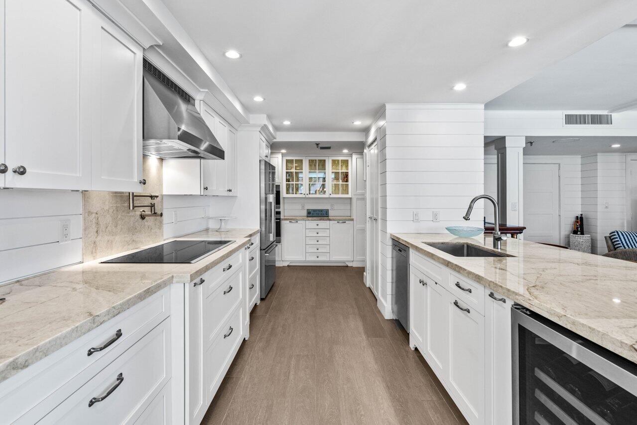 2917 South Ocean Boulevard, Unit 104 Highland Beach, FL 33487 - Photo 9 of 57 a large kitchen with a sink and cabinets
