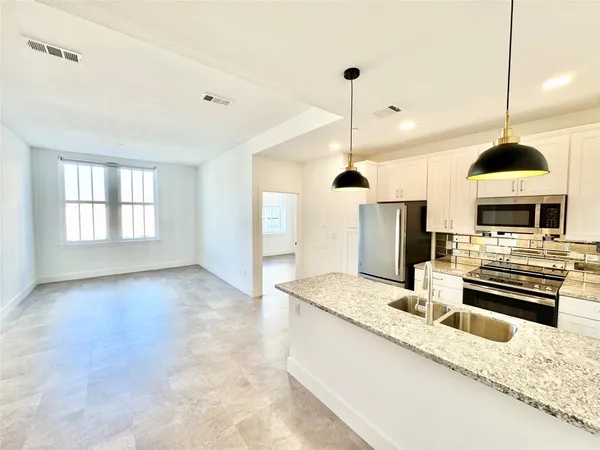 a view of kitchen with sink and microwave