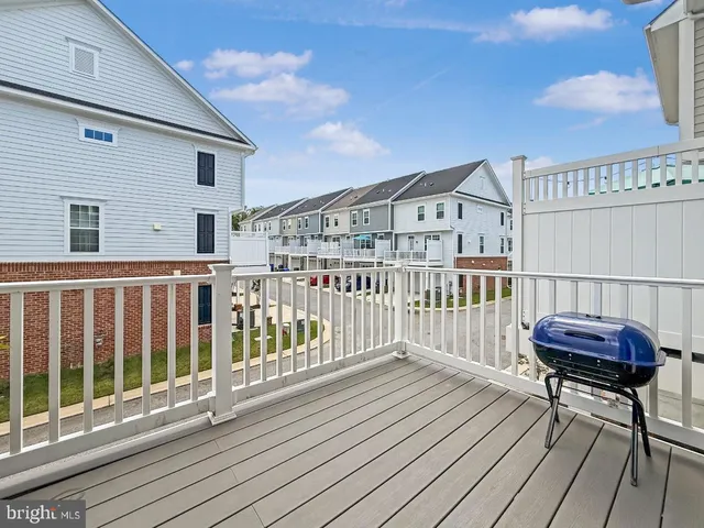 a view of a deck with wooden floor and furniture