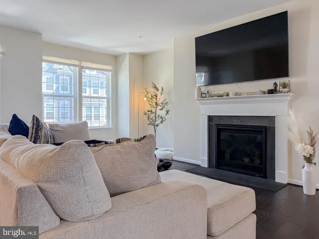 a living room with a flat screen tv and a fireplace