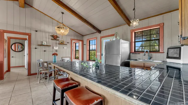 a kitchen with stainless steel appliances granite countertop a stove and a dining table view