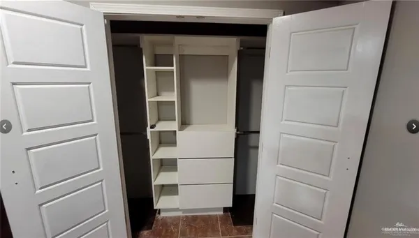 an empty room with a ceiling fan and window