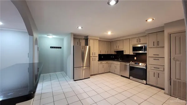 a kitchen with stainless steel appliances granite countertop a refrigerator and a sink