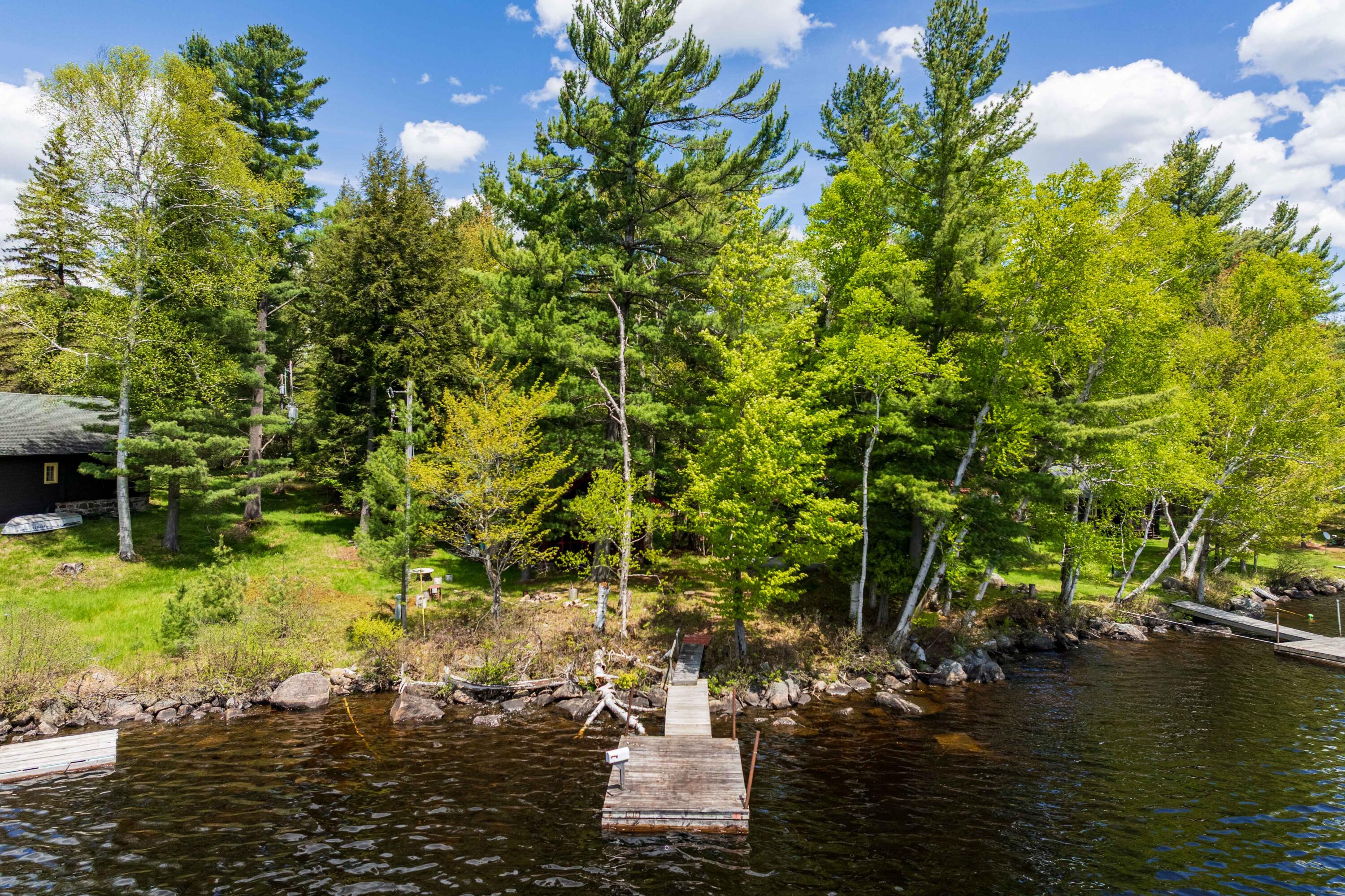 2525 North Point Road Raquette Lake, NY 13436 - Photo 4 of 48 Drone of Dock and Cabin
