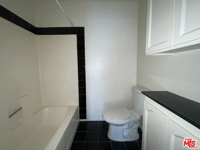 a bathroom with a toilet a sink and bathtub