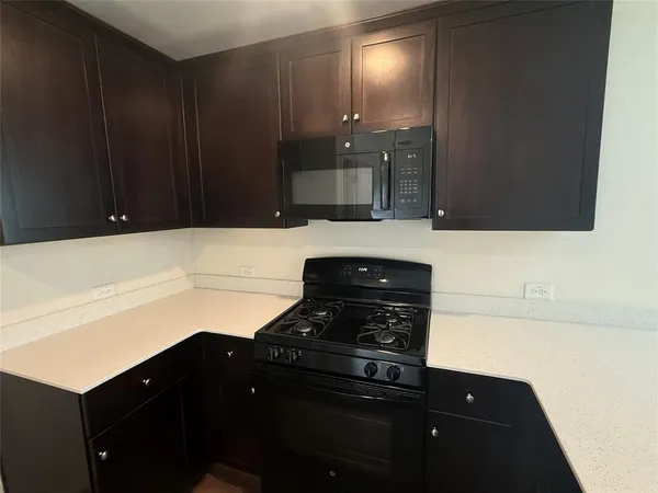 a kitchen with a sink and a stove top oven