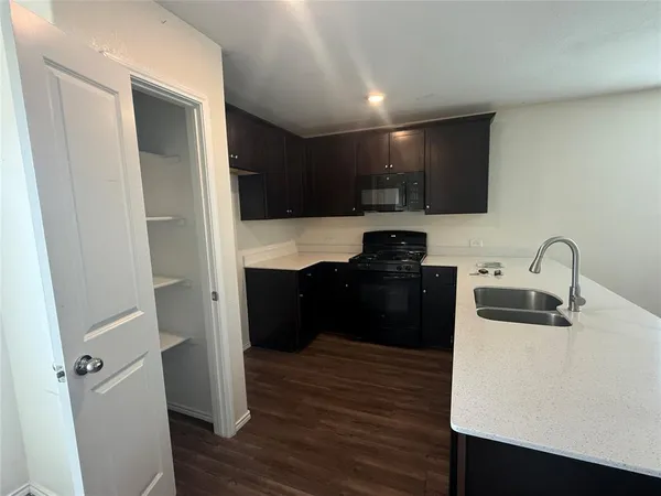 a kitchen with a refrigerator and a sink