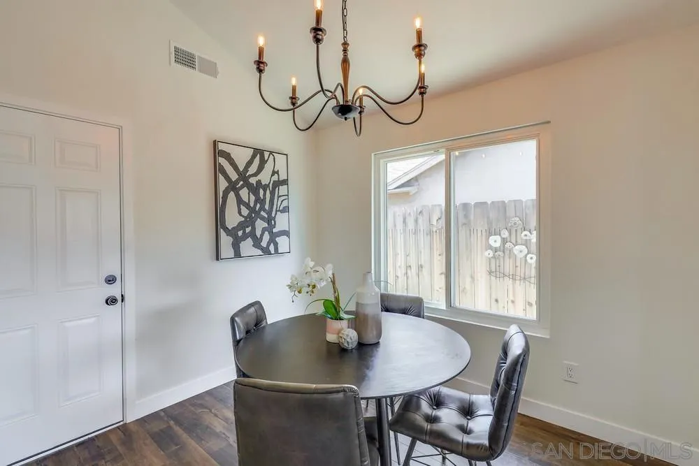 8779 Cordial Road El Cajon, CA 92021 - Photo 11 of 39 a view of a dining room with furniture window and wooden floor