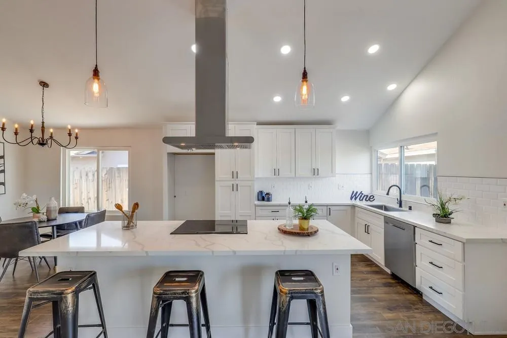 8779 Cordial Road El Cajon, CA 92021 - Photo 12 of 39 a kitchen with cabinets a sink stainless steel appliances and dining table