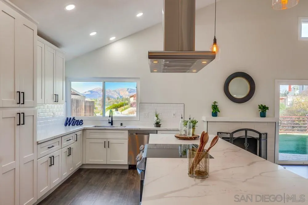 8779 Cordial Road El Cajon, CA 92021 - Photo 13 of 39 a large white kitchen with lots of counter space and a sink