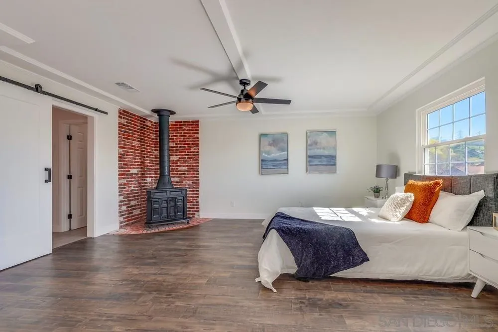 8779 Cordial Road El Cajon, CA 92021 - Photo 17 of 39 a bedroom with a large bed and a ceiling fan