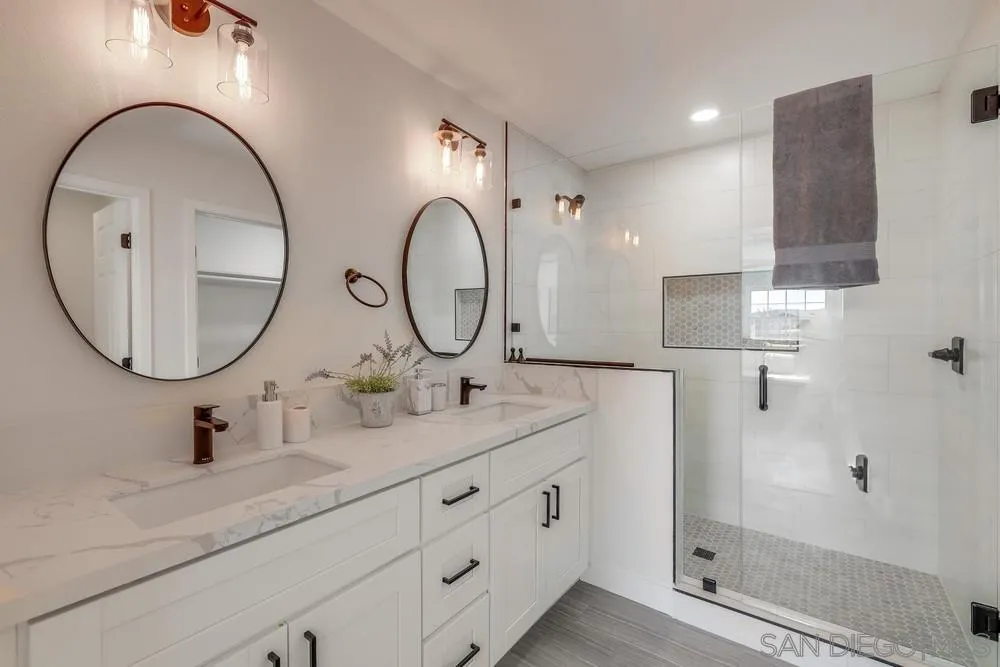8779 Cordial Road El Cajon, CA 92021 - Photo 19 of 39 a bathroom with a double vanity sink and a mirror