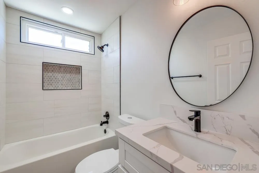 8779 Cordial Road El Cajon, CA 92021 - Photo 30 of 39 a bathroom with a sink a toilet and a mirror