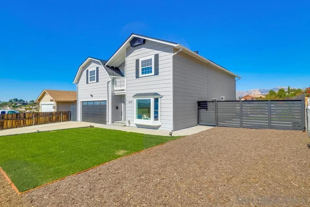 8779 Cordial Road El Cajon, CA 92021 - Photo 3 of 39 a front view of a house with a yard