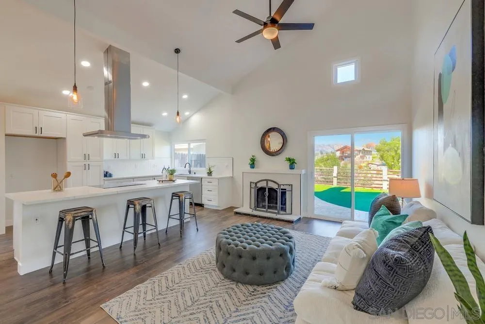 8779 Cordial Road El Cajon, CA 92021 - Photo 8 of 39 a living room with furniture a fireplace and a table