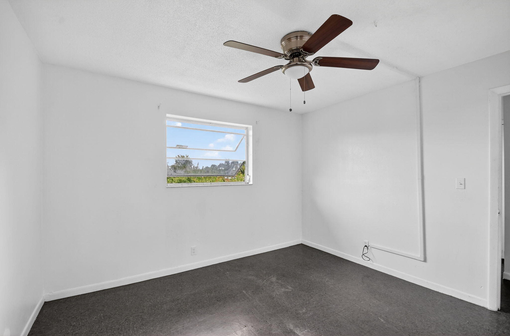 1406 Barton Road, Unit 15 Lake Worth Beach, FL 33460 - Photo 15 of 19 an empty room with a window and a fan