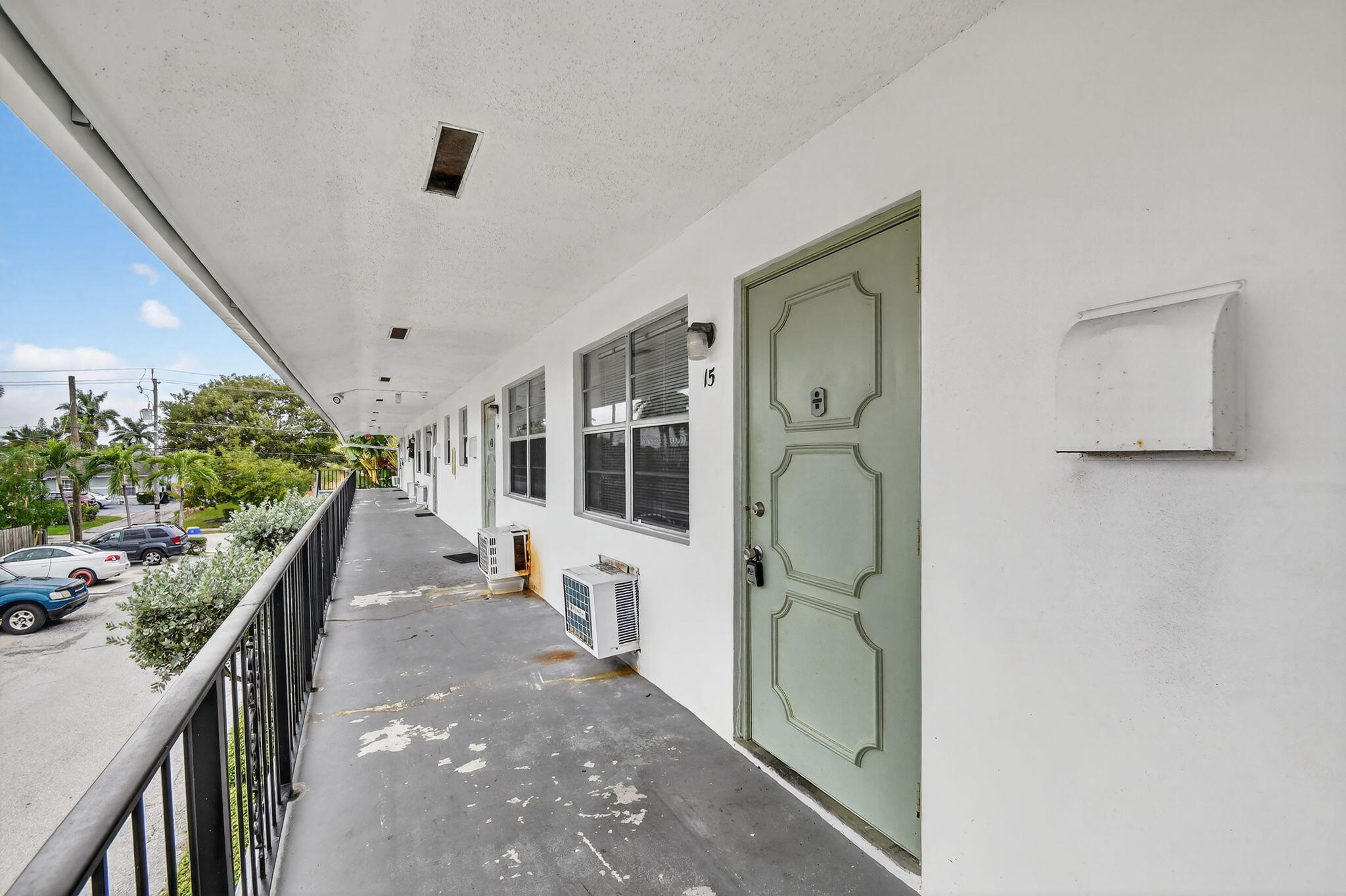 1406 Barton Road, Unit 15 Lake Worth Beach, FL 33460 - Photo 4 of 19 a hallway with a door and stairs