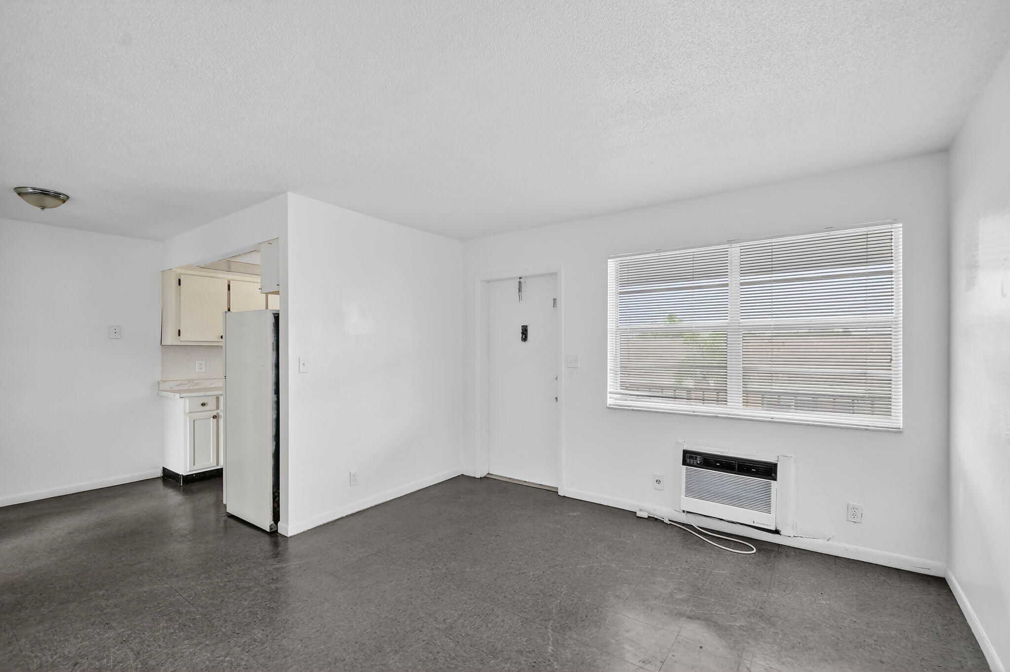 1406 Barton Road, Unit 15 Lake Worth Beach, FL 33460 - Photo 7 of 19 an empty room with a empty space and windows