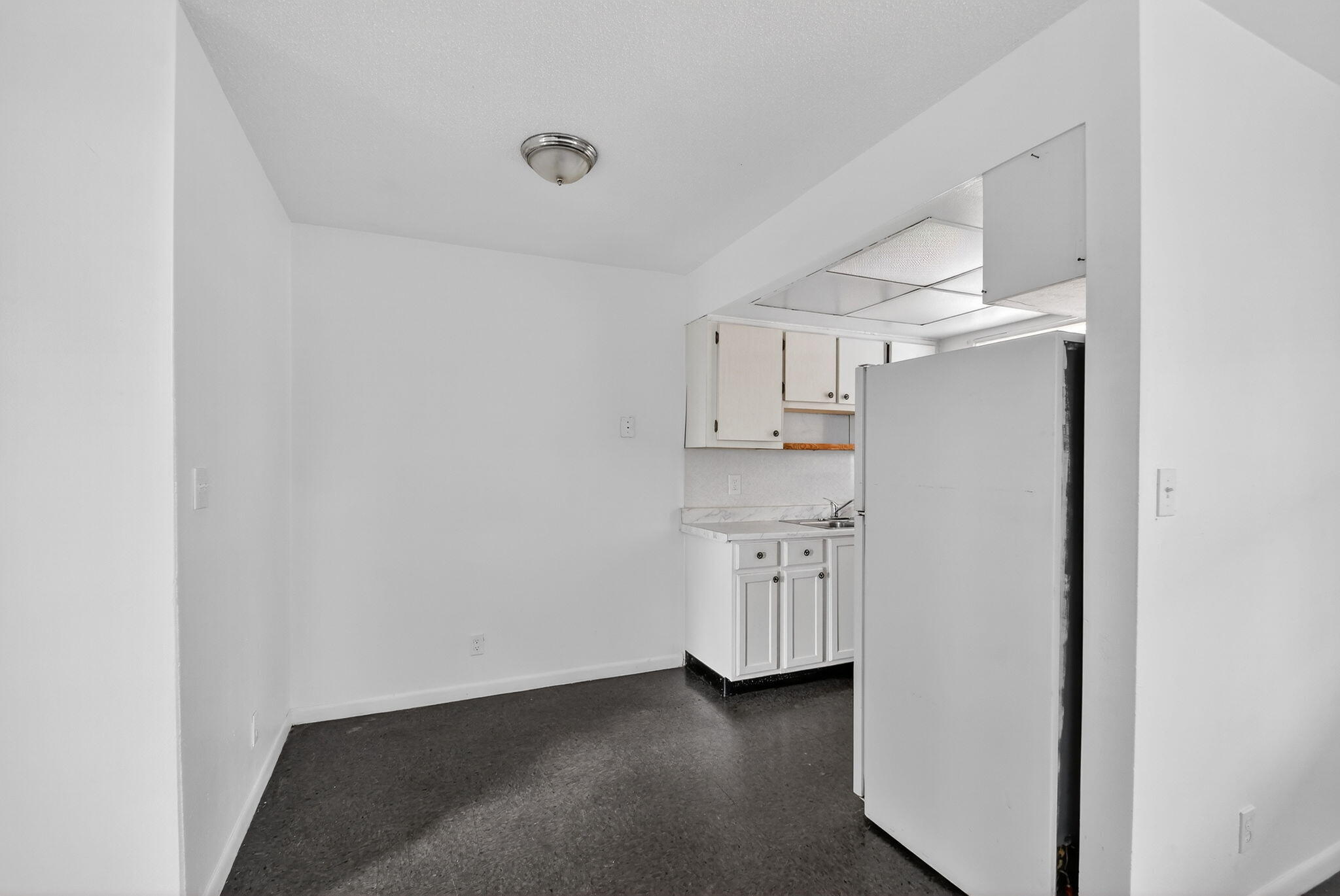 1406 Barton Road, Unit 15 Lake Worth Beach, FL 33460 - Photo 9 of 19 a view of a kitchen with cabinets