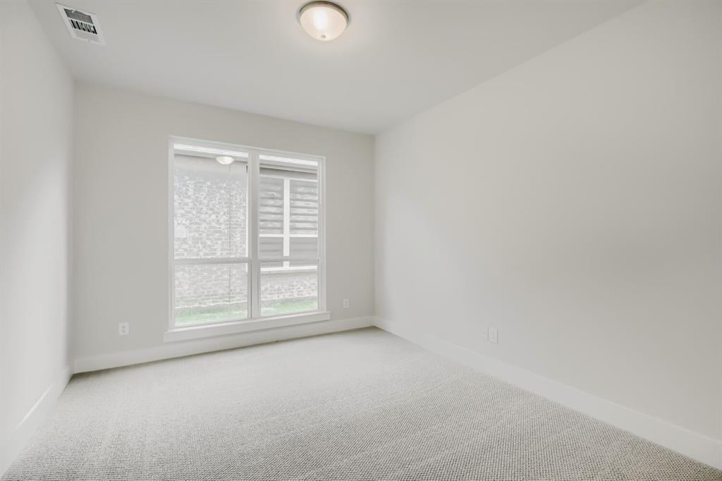 4407 Windy Point Road Oak Point, TX 75068 - Photo 5 of 27 Neutral-toned room featuring a single window, recessed ceiling light, and light gray wall-to-wall carpeting