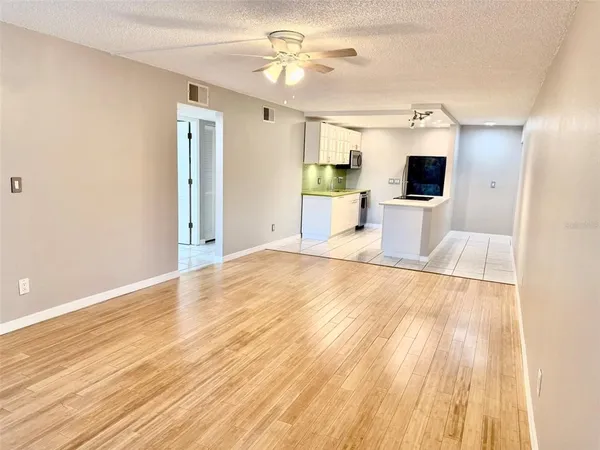 a view of a bedroom with wooden floor