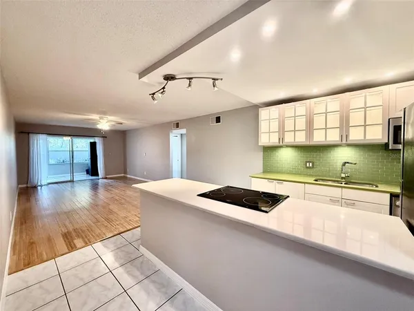 a kitchen with a stove and white cabinets