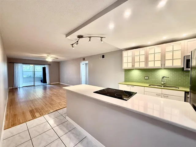 a kitchen with a stove and white cabinets