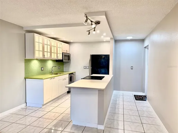 a kitchen with stainless steel appliances a refrigerator sink and stove