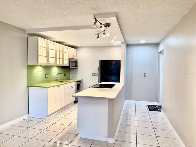 a kitchen with stainless steel appliances a refrigerator sink and stove