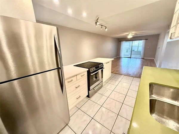 a bathroom with a sink a microwave and bathtub