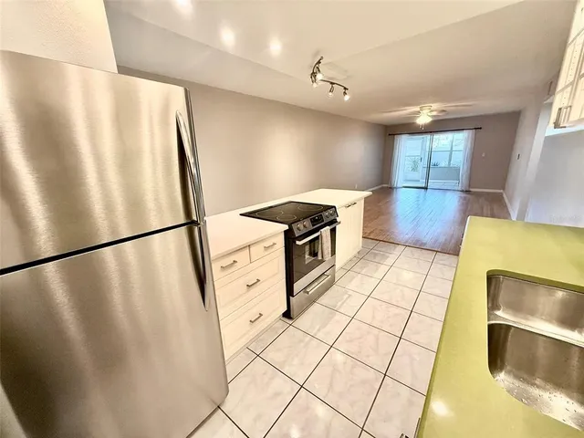 a bathroom with a sink a microwave and bathtub