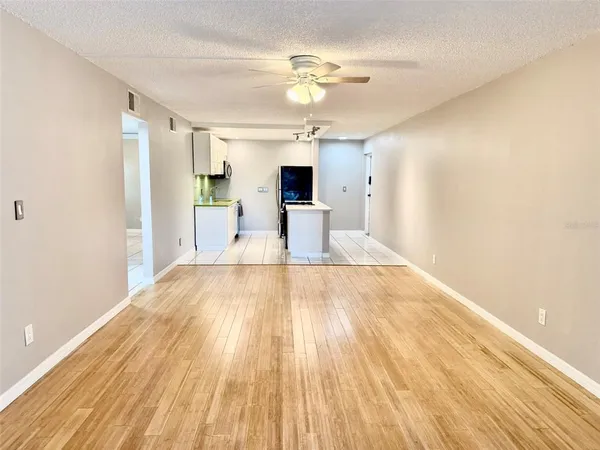 a view of a living room a bathroom and wooden floor