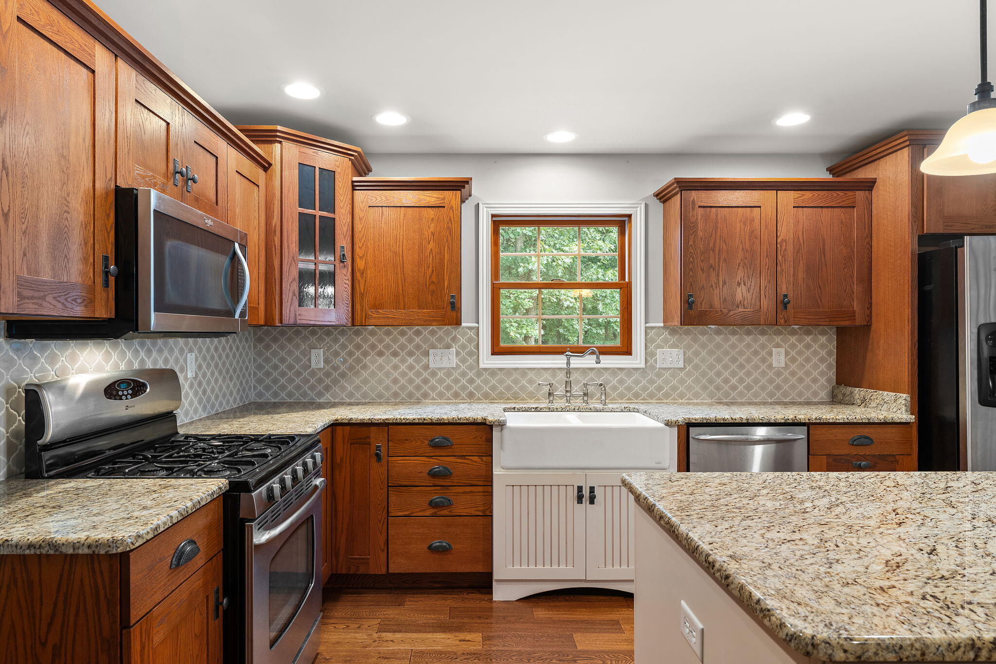 5338 East Lawler Court, Unit 67 Demotte, IN 46310 - Photo 17 of 49 a kitchen with stainless steel appliances granite countertop wooden cabinets stove top oven and sink