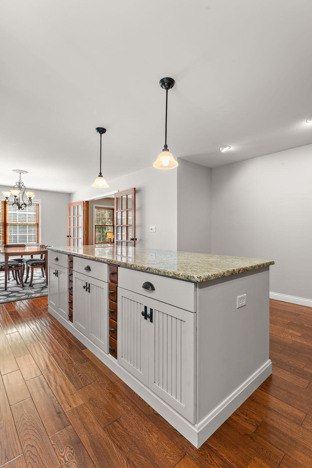 5338 East Lawler Court, Unit 67 Demotte, IN 46310 - Photo 18 of 49 a kitchen with granite countertop a stove a sink and a wooden floors