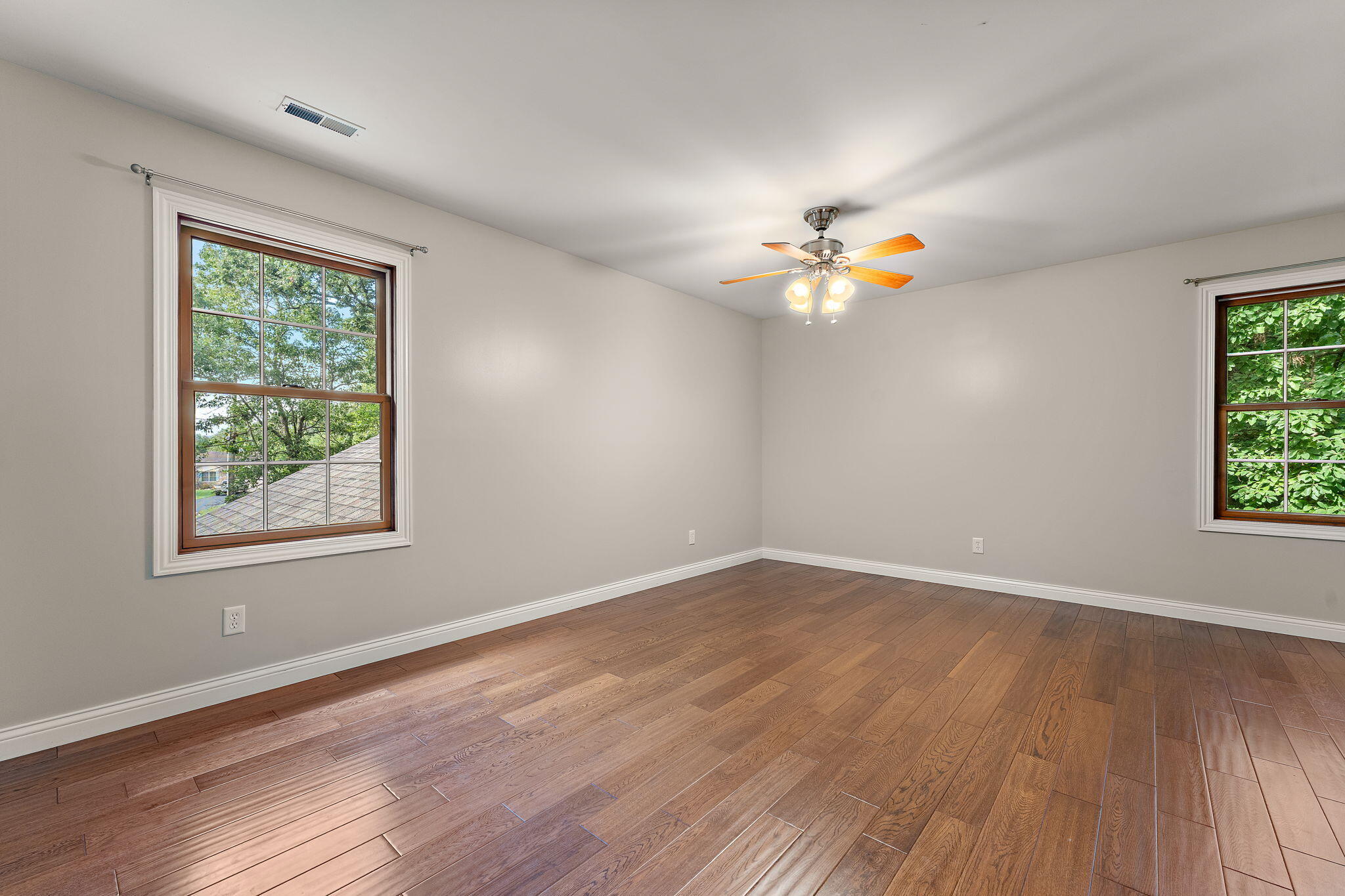5338 East Lawler Court, Unit 67 Demotte, IN 46310 - Photo 28 of 49 a view of an empty room with a window and wooden floor