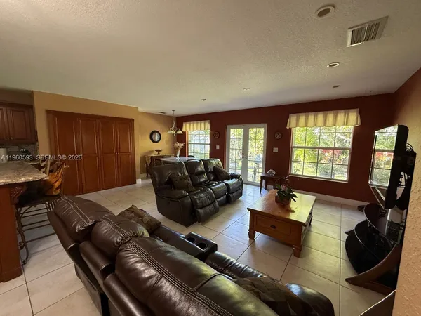 a living room with furniture fireplace and a large window