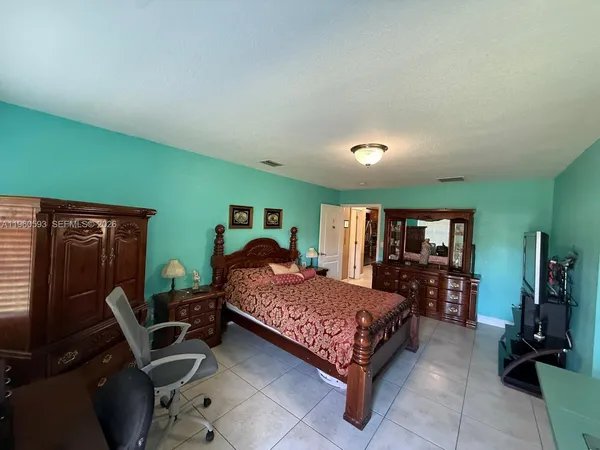 a bedroom with a bed and dresser