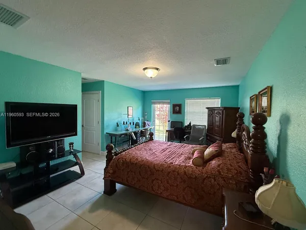 a bed room with a bed window and a television