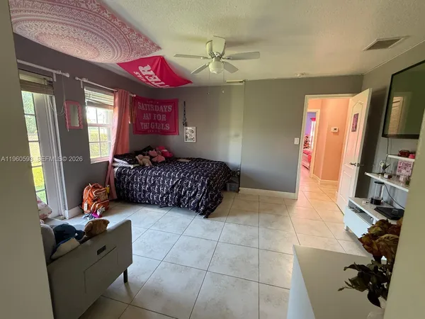 a bedroom with furniture and a flat screen tv