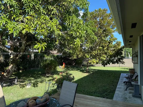 a view of backyard with seating area and green space