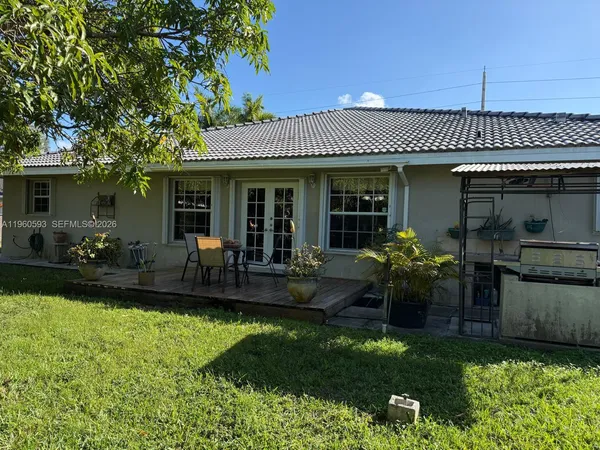 a view of a house with backyard sitting area and garden