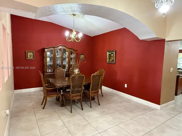 a view of a dining room with furniture and chandelier