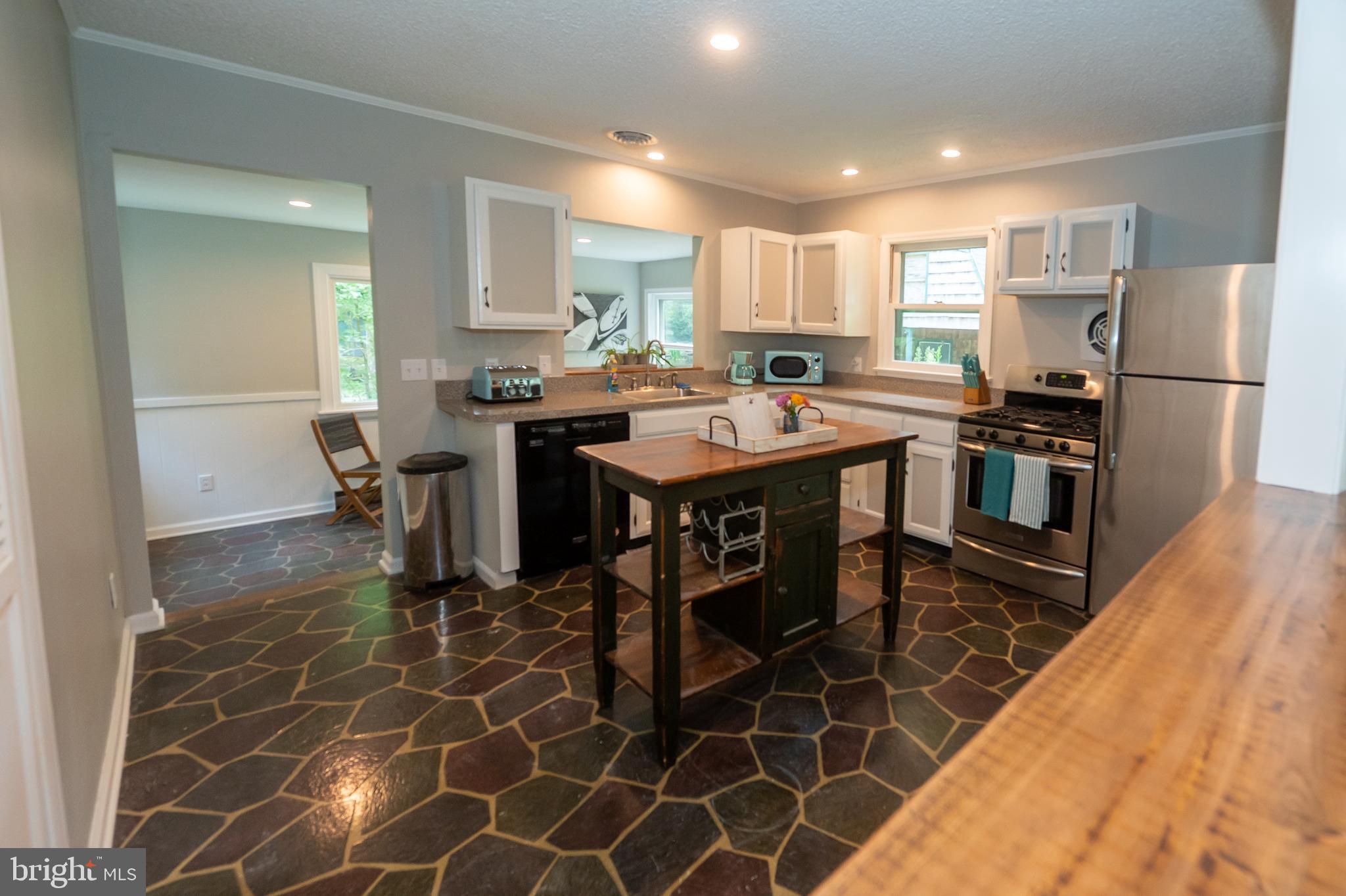 31091 Carioca Road Delmar, MD 21875 - Photo 11 of 28 a kitchen with kitchen island a sink table and chairs