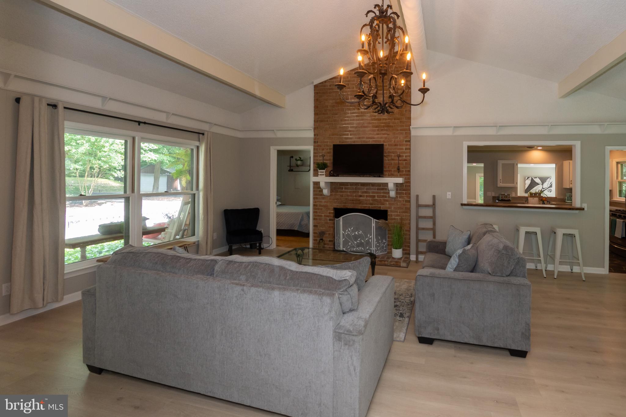 31091 Carioca Road Delmar, MD 21875 - Photo 4 of 28 a living room with furniture a flat screen tv and a fireplace